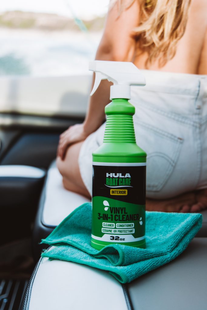Hula Boat Care vinyl 3-in-1 cleaner conditioner and ceramic UV protectant spray bottle on boat seat